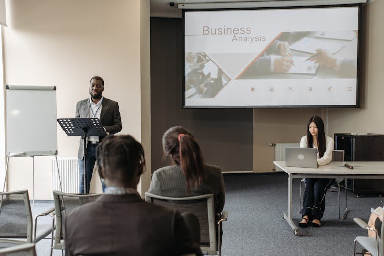 A Man Speaking At A Business Seminar