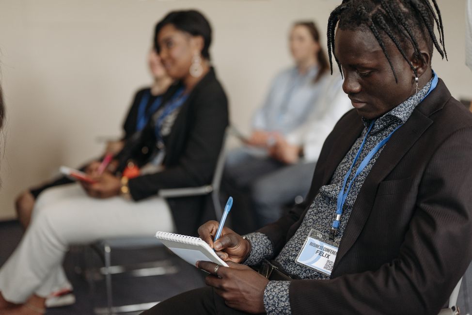 Conference audience taking notes