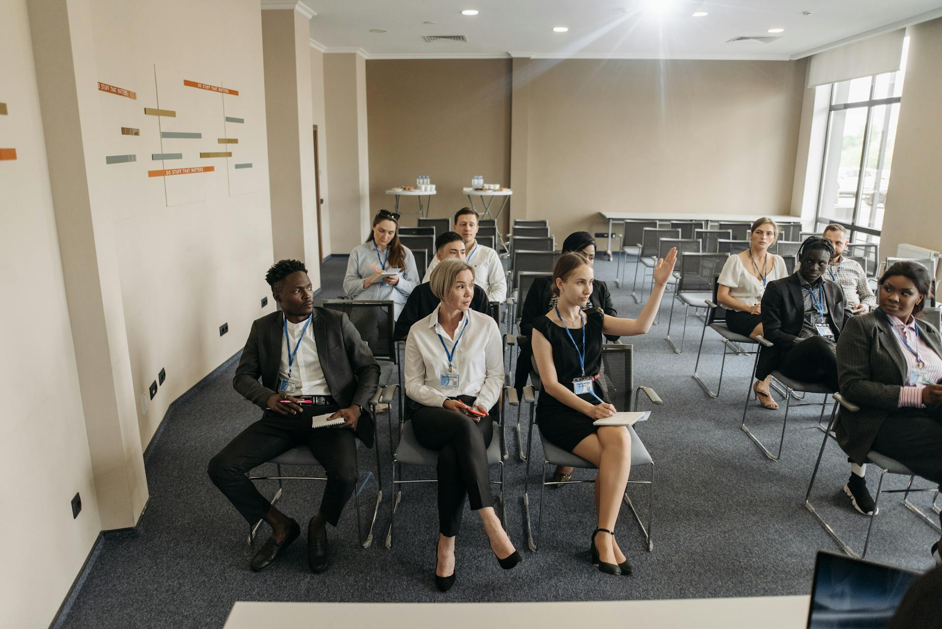 Participants Looking at the Woman Raising Hand