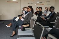 A Group of People Sitting Inside the Conference Room