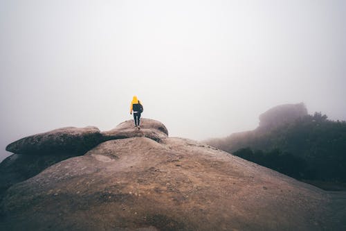A Person Walking on a Rocky Hill