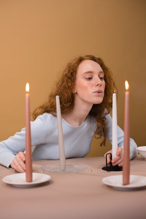 A Woman Blowing a Candle