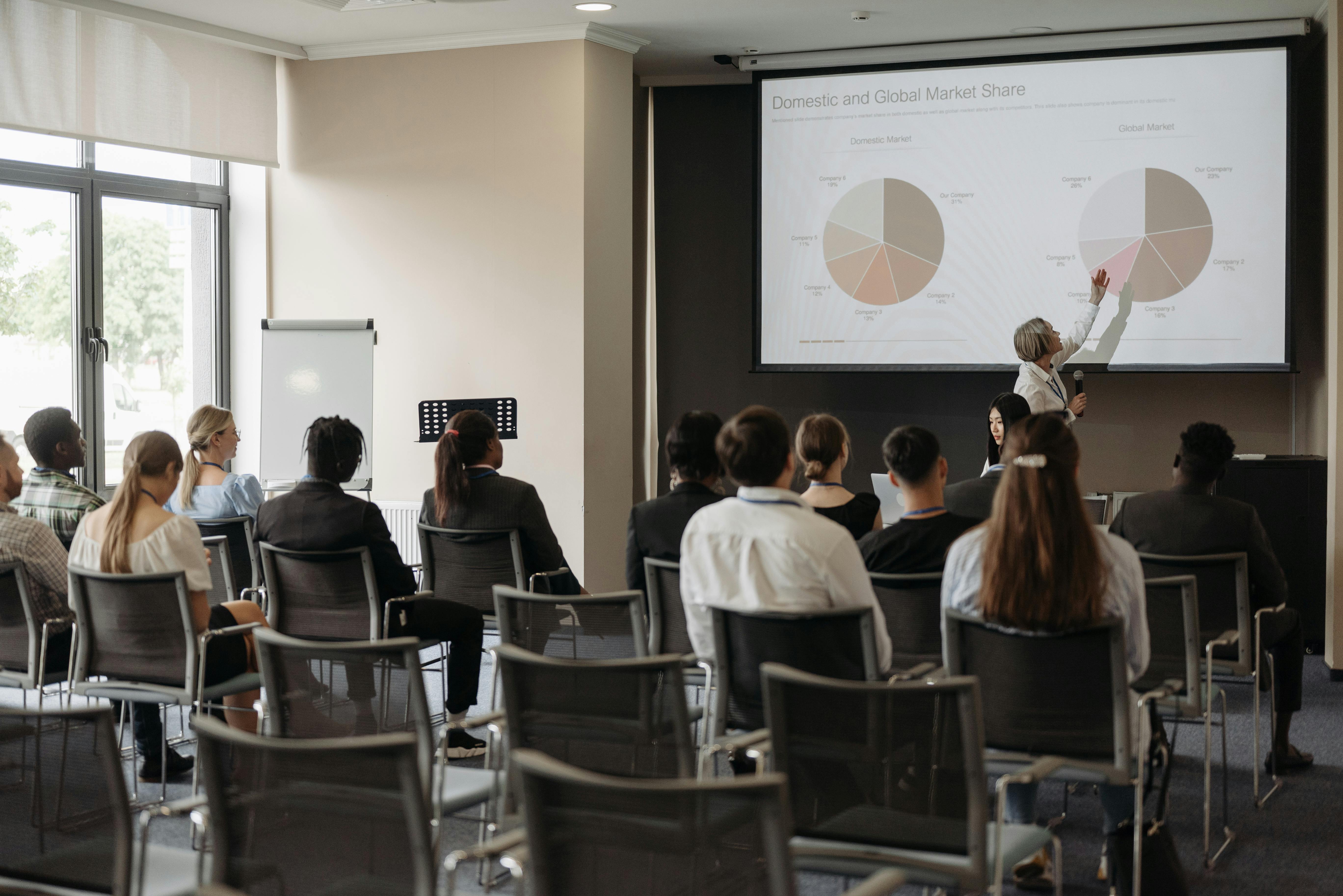 people sitting in front of the projector screen