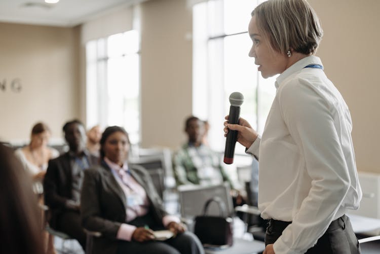 A Businesswoman Talking On A Microphone