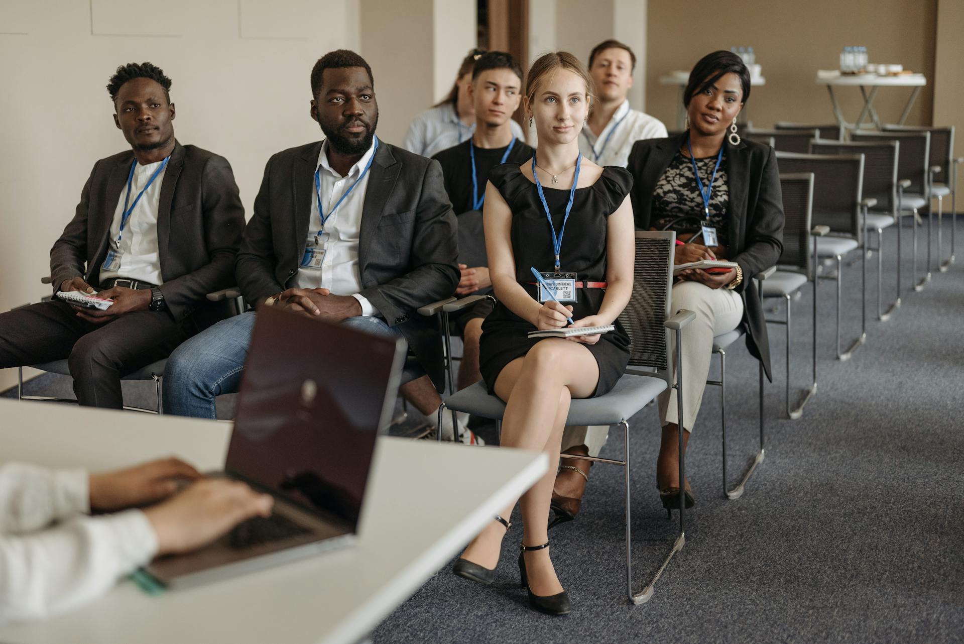 Diverse group of business professionals attentively attending a conference session.