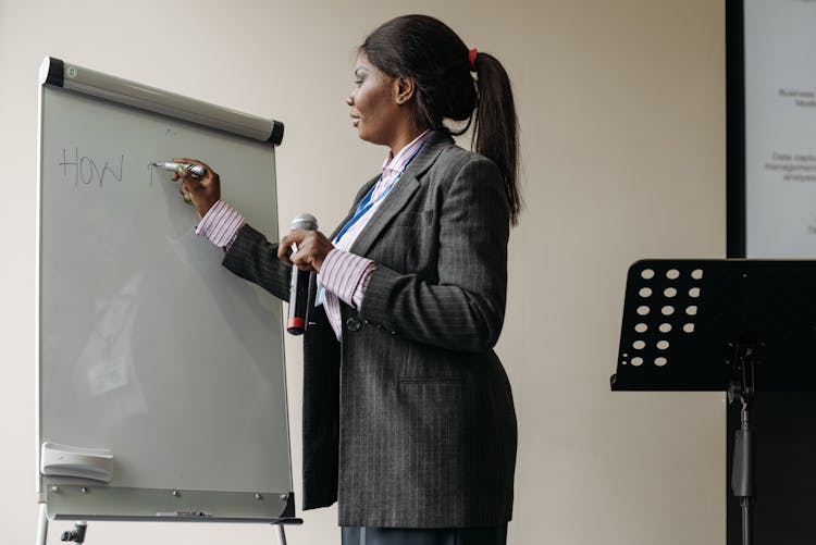 A Businesswoman Writing On Whiteboard