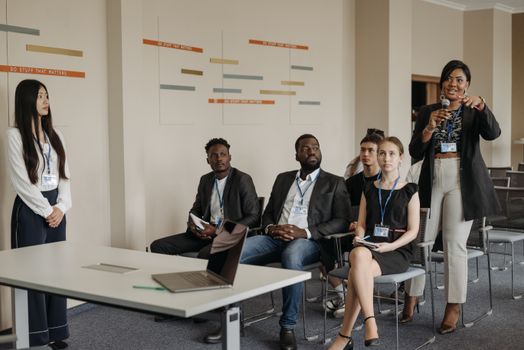 A diverse group of professionals attending a business seminar, actively participating and engaging in discussions.