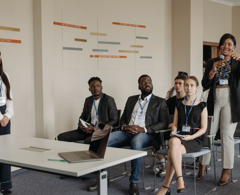 Employees engaged in training for Circular Economy practices in a corporate setting.