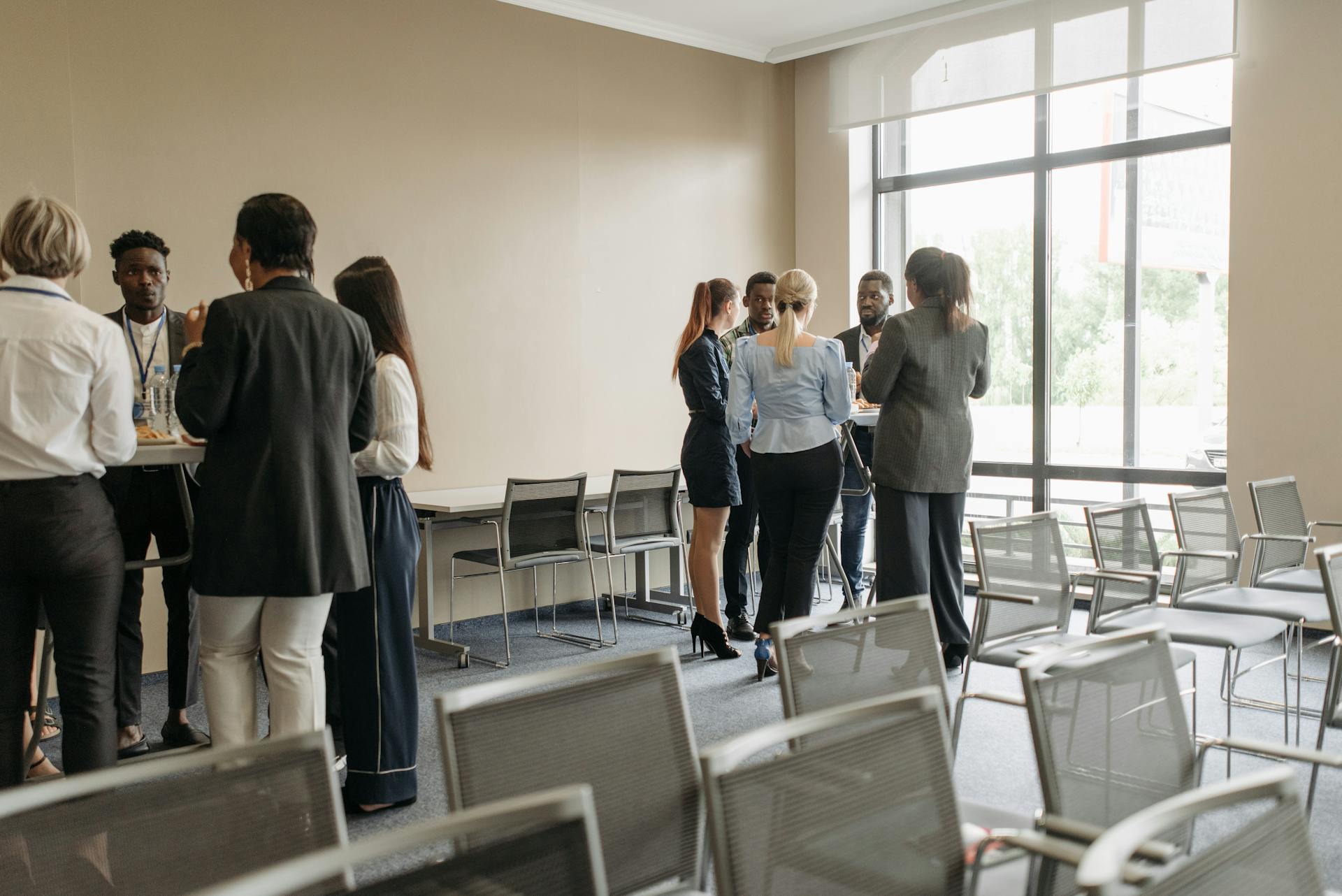 Professionals engaging in a casual networking session during a business conference.