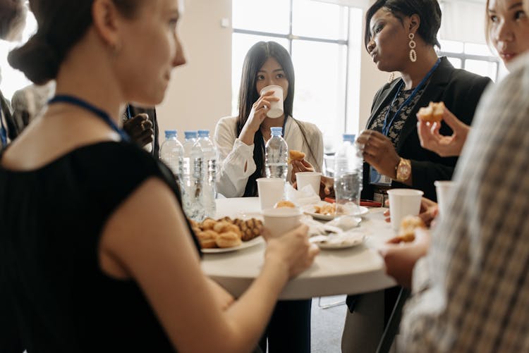 A Group Of People Talking In The Office