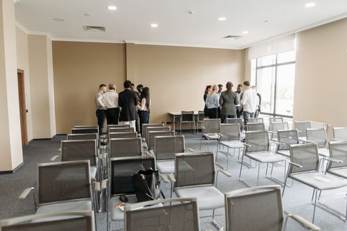 Free A diverse group of professionals having a discussion in an empty conference room. Stock Photo