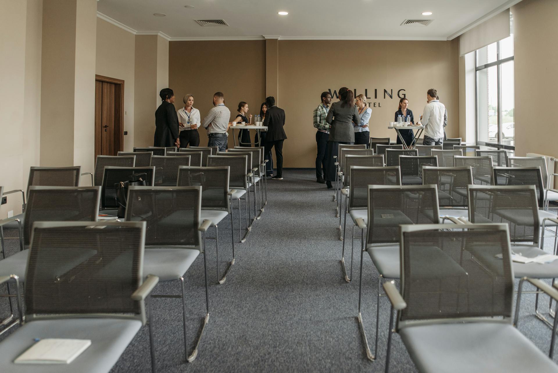 Group of People Standing and Talking in a Room