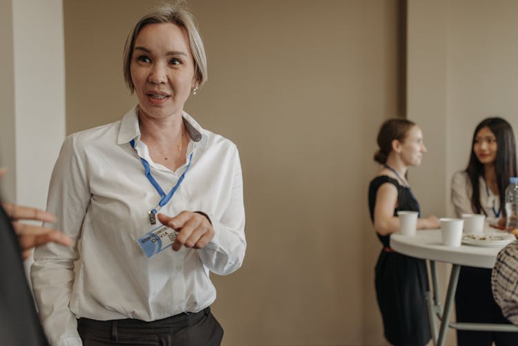 Woman In White Long Sleeves Wearing Lanyard