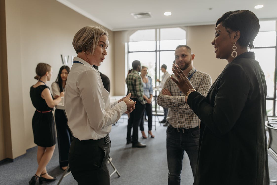 Free Group of People Wearing Long Sleeves Talking in a Room Stock Photo