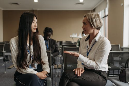 Free Two Women Talking in the Office Stock Photo