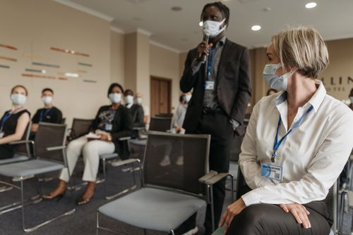 Free Diverse group of professionals in a business meeting wearing masks for safety. Stock Photo