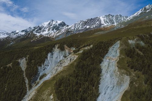Free Captivating aerial landscape of the Altai Mountains in Russia with snow-capped peaks and lush greenery. Stock Photo
