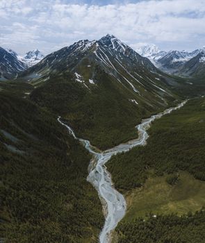 Breathtaking aerial view of the Altai Mountains with a flowing river in Russia's Kosh-Agachsky District.