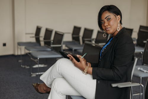 A Woman Wearing Blazer Sitting in a Conference Room