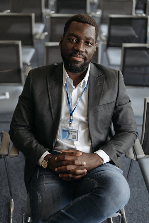 A Man in Gray Suit Sitting on a Chair