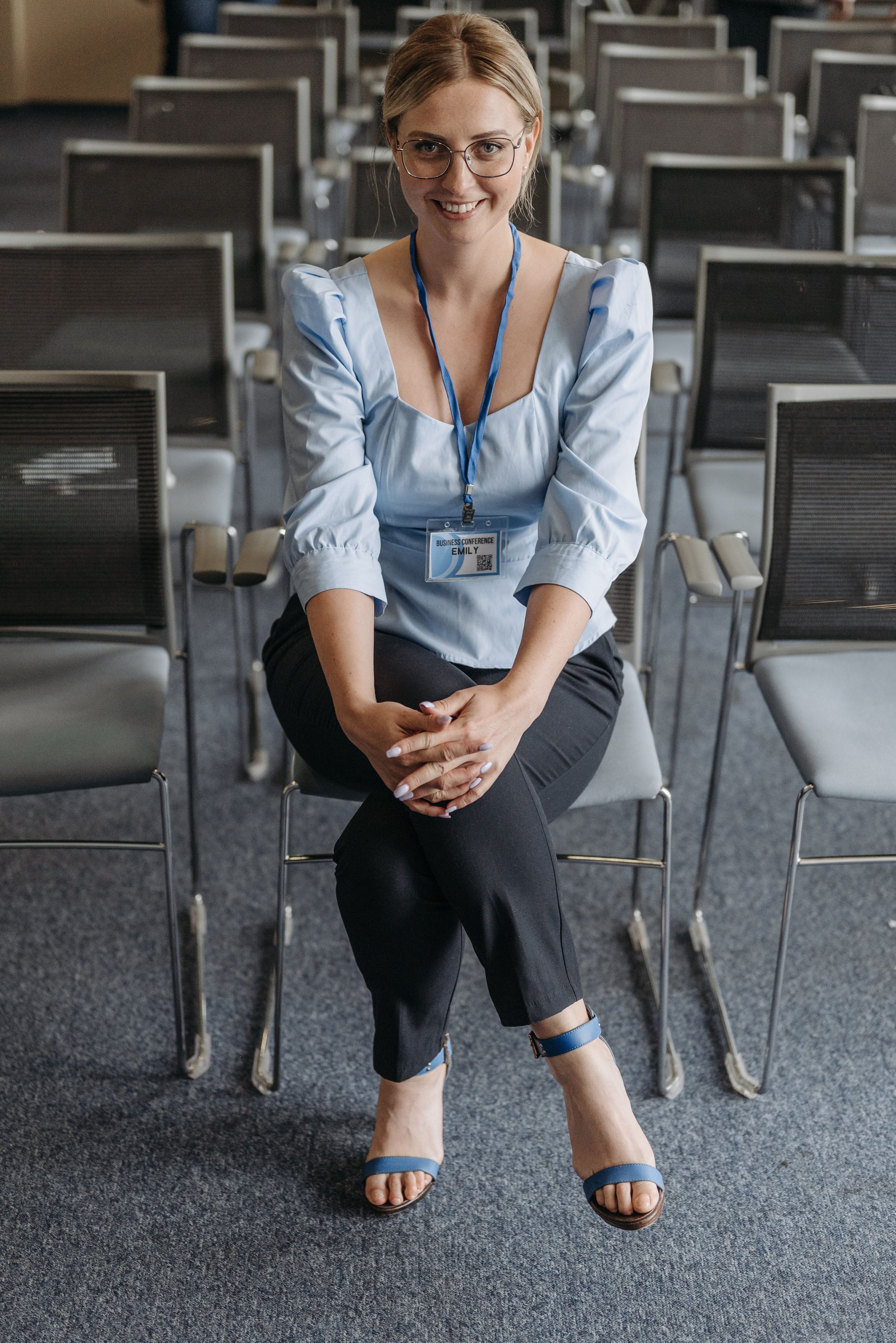 A Woman in Blue Top Sitting on a Chair · Free Stock Photo