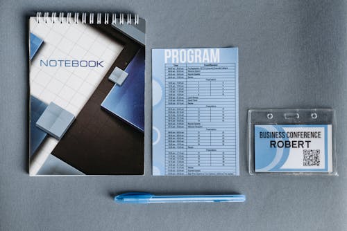 Free Blue Pen Beside Paper Printout and Spiral Notebook Stock Photo