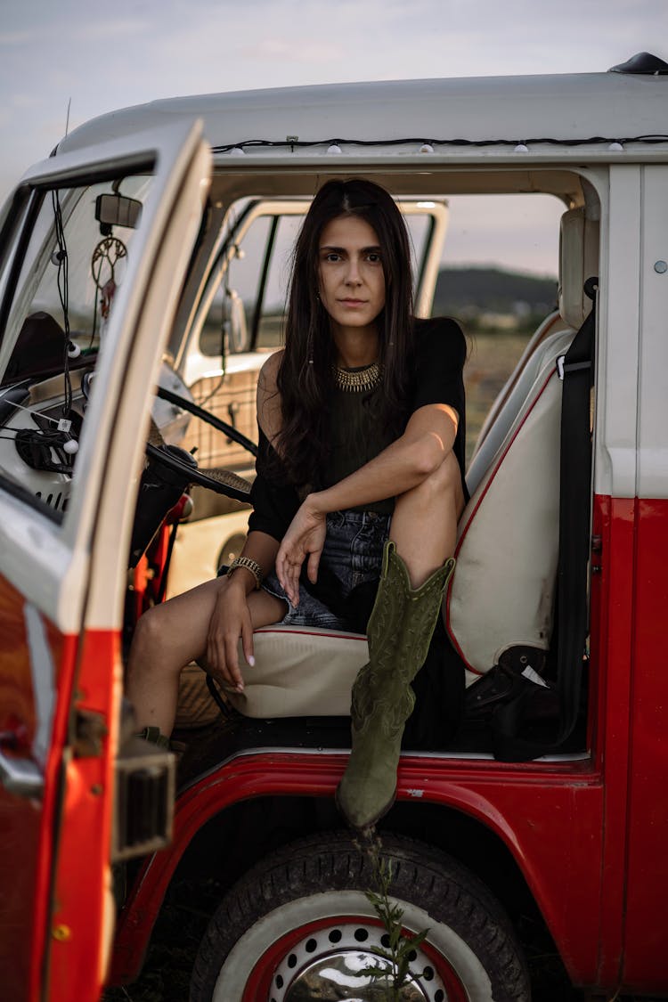 Woman In Boho Outfit Sitting In A Driver Seat Of A Retro Volkswagen T1