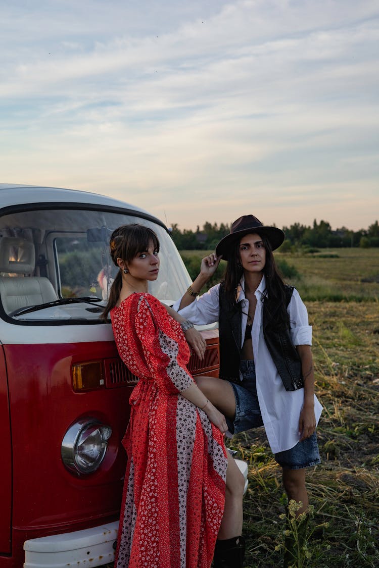 Women In Boho Outfits Standing Next To A Retro Volkswagen T1