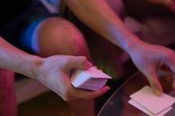 A Person Putting Cards on Table