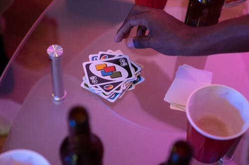 Free Close-Up Shot of a Person Picking an Uno Card Stock Photo