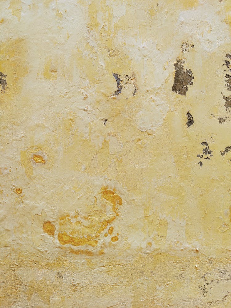 Yellow Paint Peeling Off On Concrete Wall