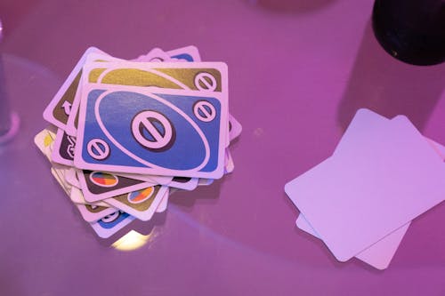 Blue and White Playing Cards on  Pink Surface