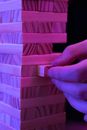 A Person Pulling a Jenga Piece