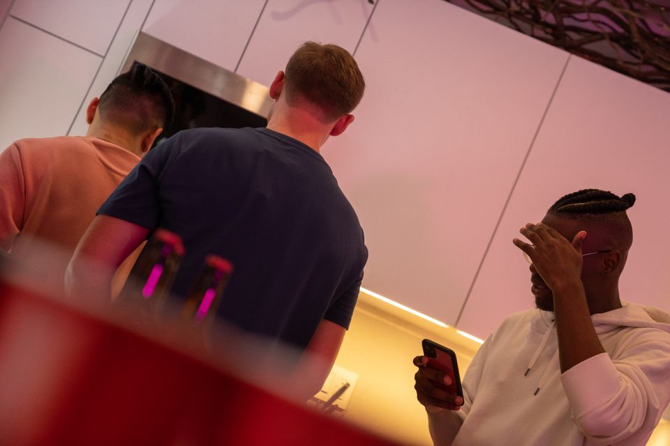 A group of friends cooking together in a modern kitchen