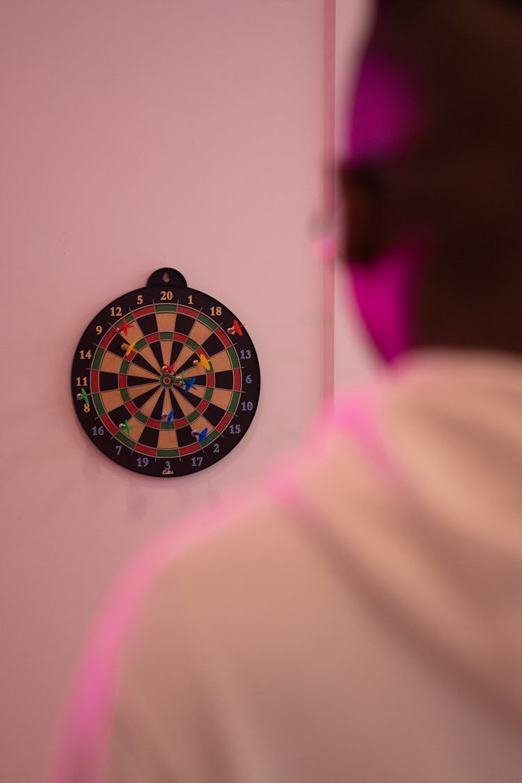 A Dart Mounted On The White Wall