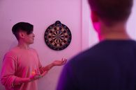 Woman in Pink Long Sleeve Shirt Holding Pink and White Round Wall Decor