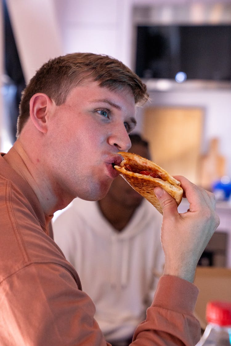 A Man Eating Pizza