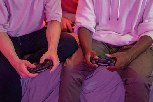 Two friends playing video games together at home, using controllers.