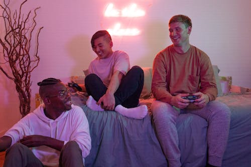 Men Sitting Holding Games Controllers 
