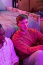 Man in Pink Sweater Sitting Beside Woman in Pink Sweater