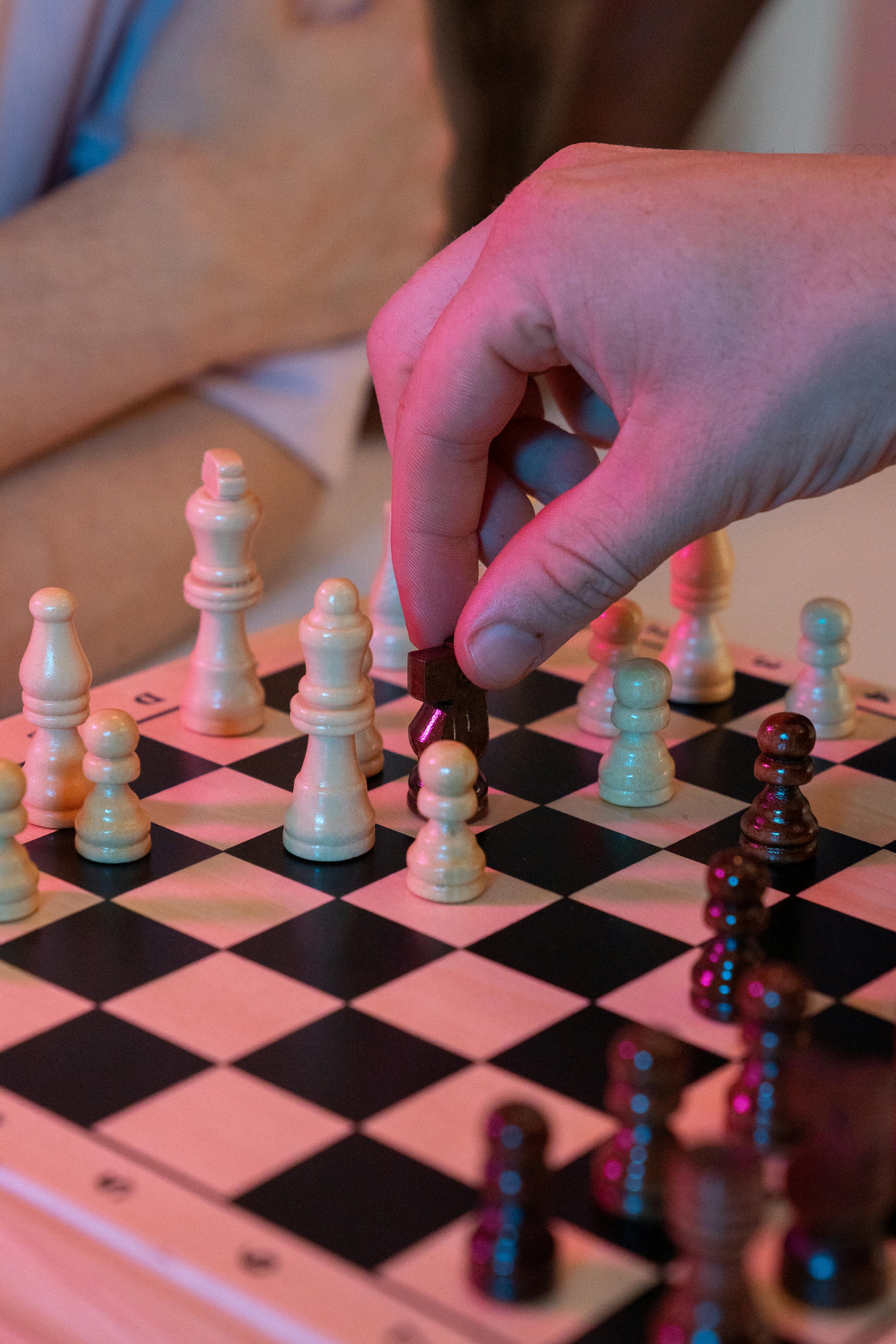 hand playing chess