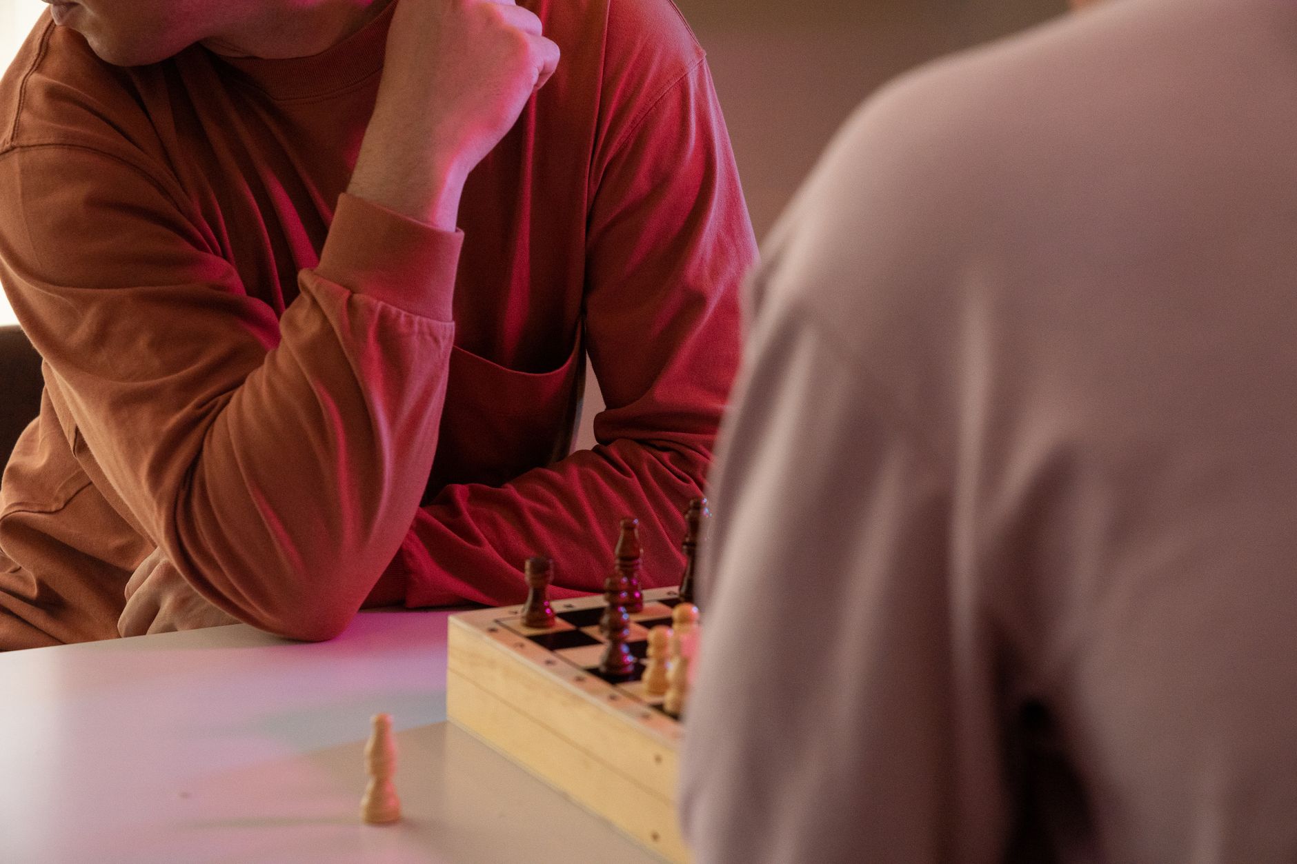 Close-up view of people playing chess, focusing on strategy and concentration.