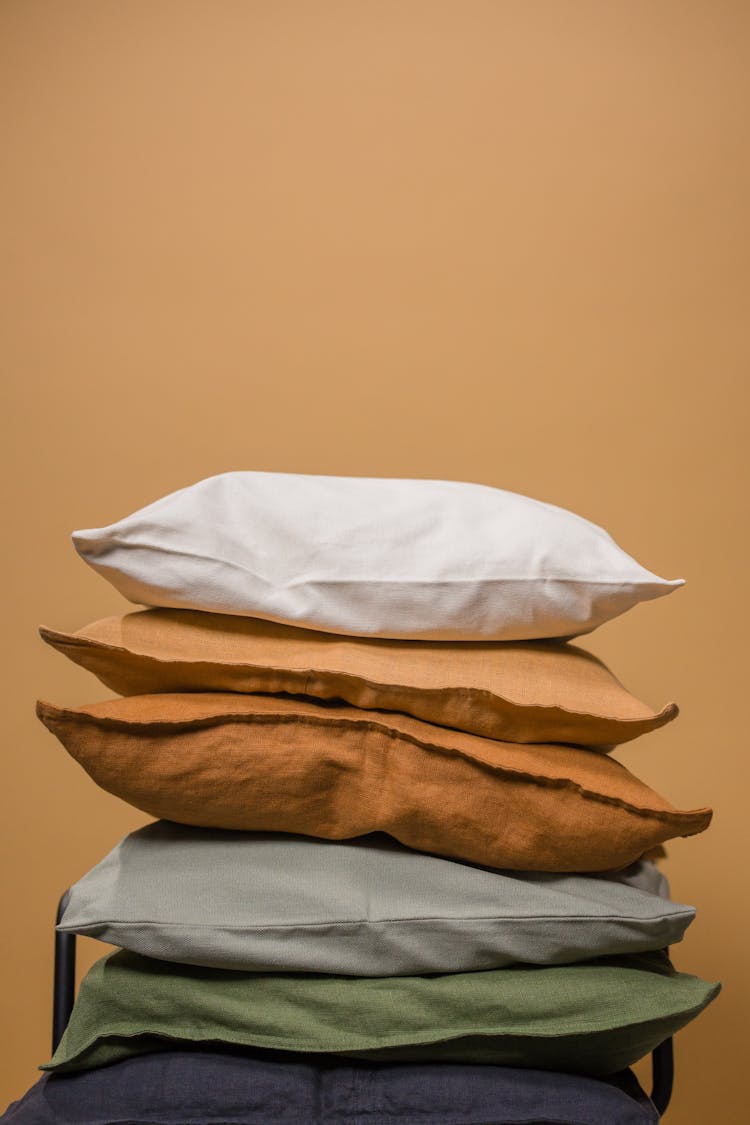 Stack Of Pillows In Brown Background 