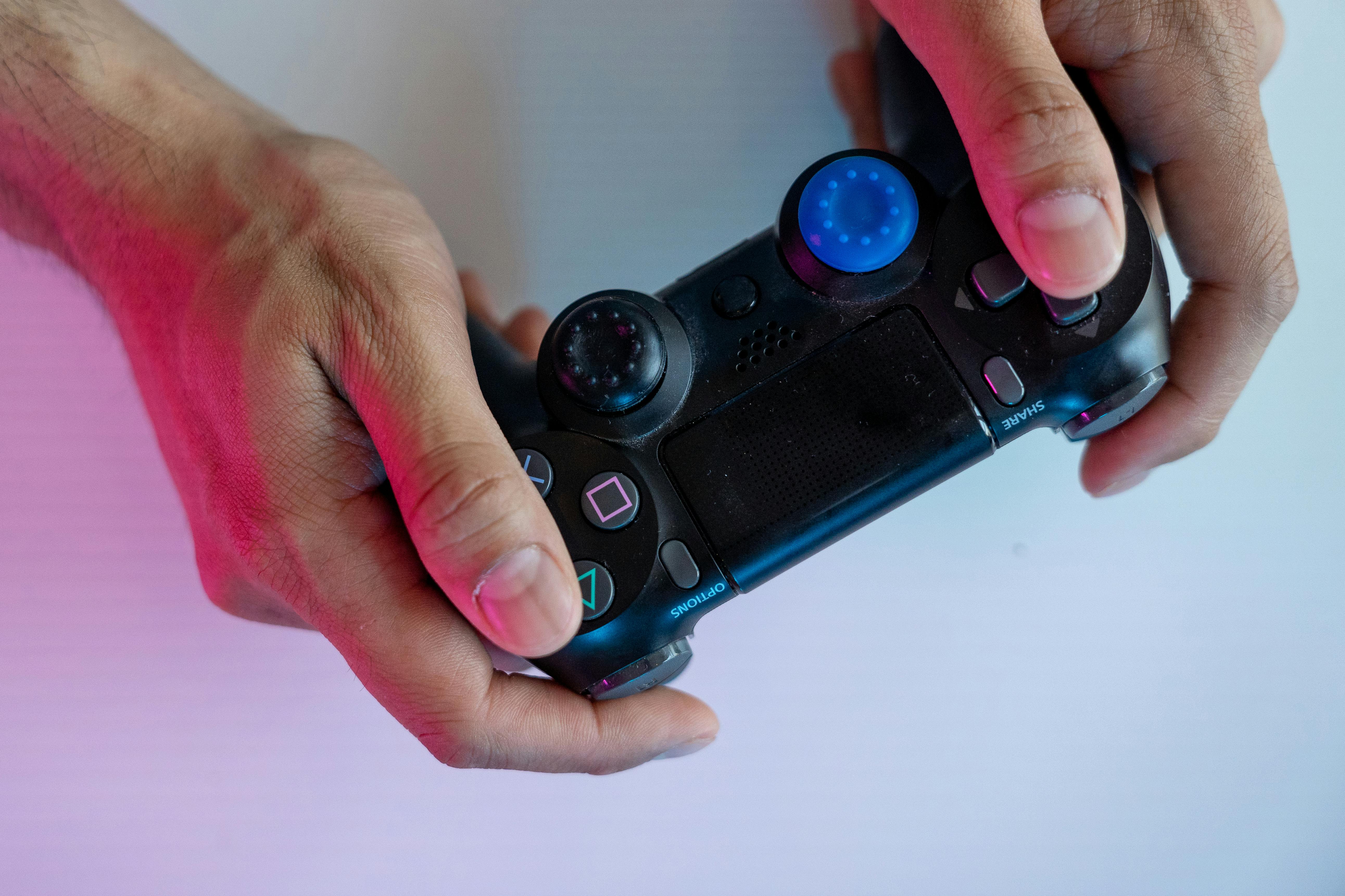 person holding black game controller