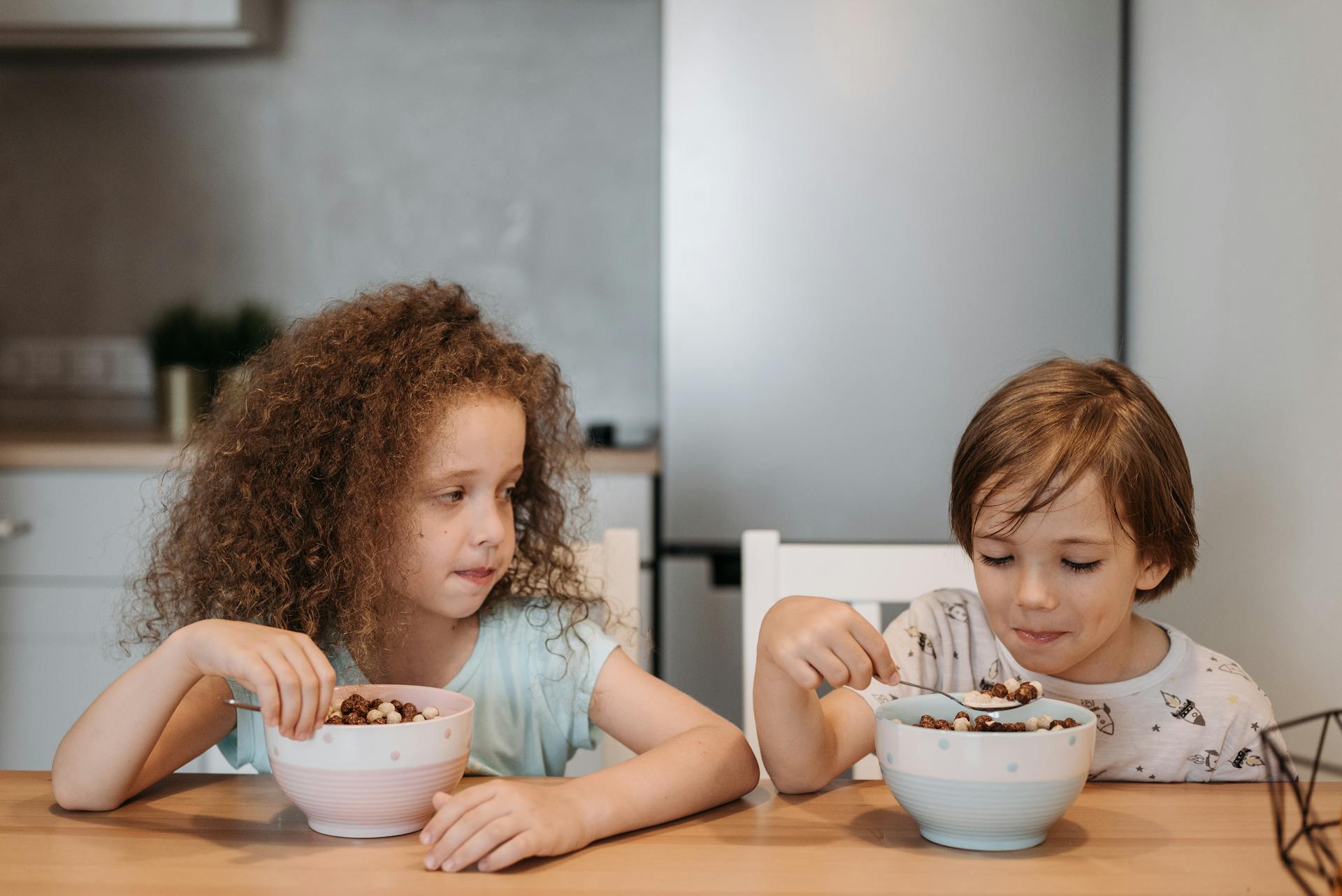 Boy and Girl Eating Cereals