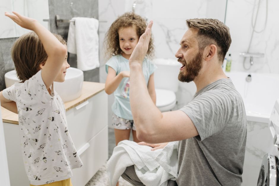 Family using multiple hot water fixtures simultaneously in a modern home Family using multiple hot water fixtures simultaneously in a modern home