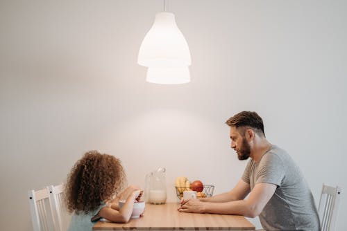 A Man Having Breakfast with his Child