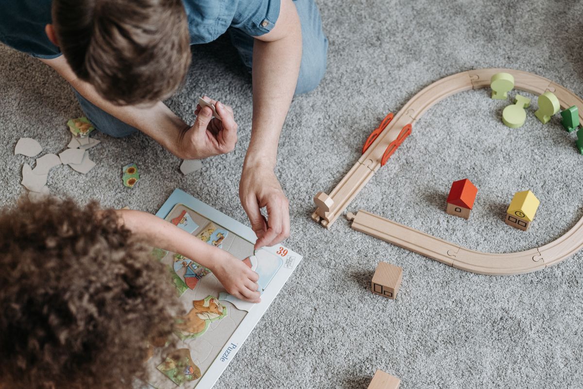 Child working on puzzles and creative toys