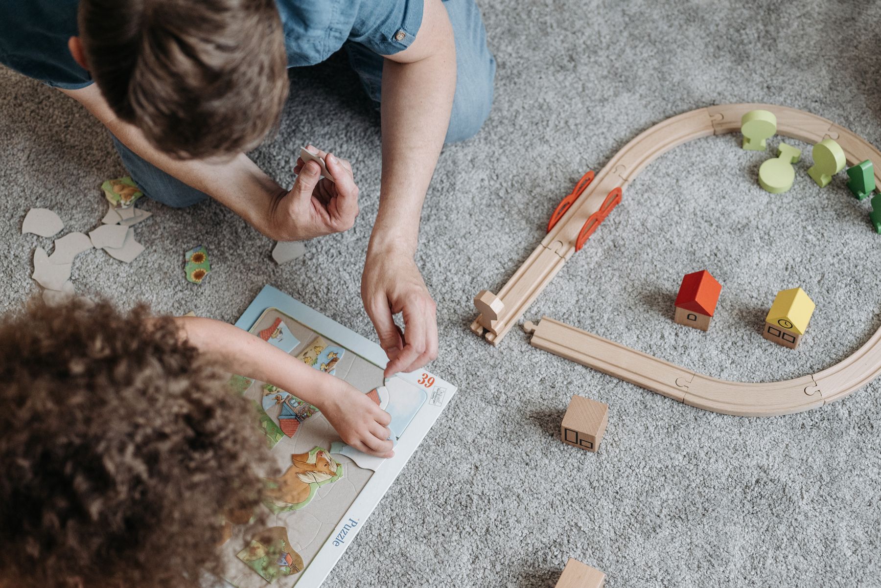 Children exploring puzzles and wooden toys together during creative play