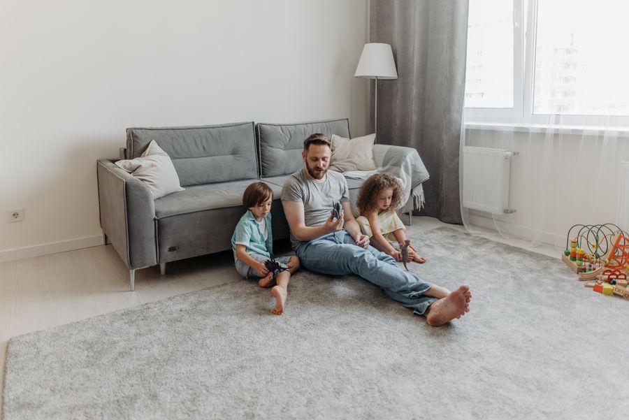 Family laughing together on a freshly cleaned plush carpet in their Phoenix living room